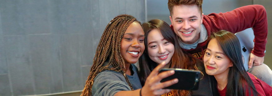 Students pose together for a selfie