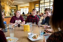 Students eat together at a dining hall