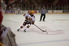 A hockey player skates down the ice